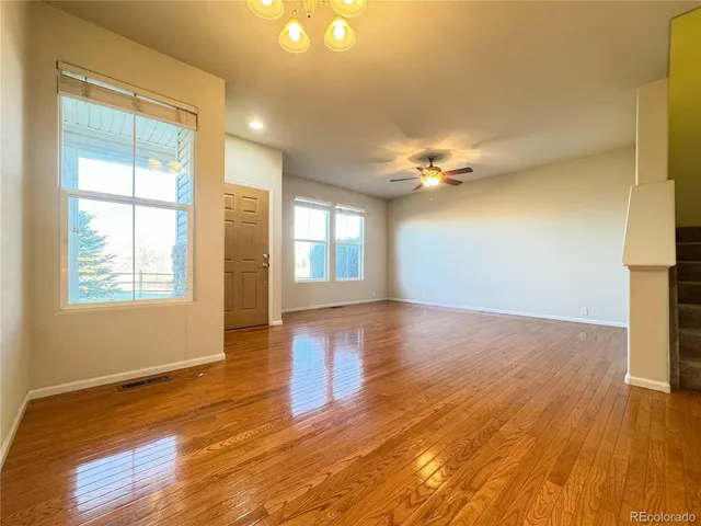 a view of a kitchen with a sink and a ceiling fan