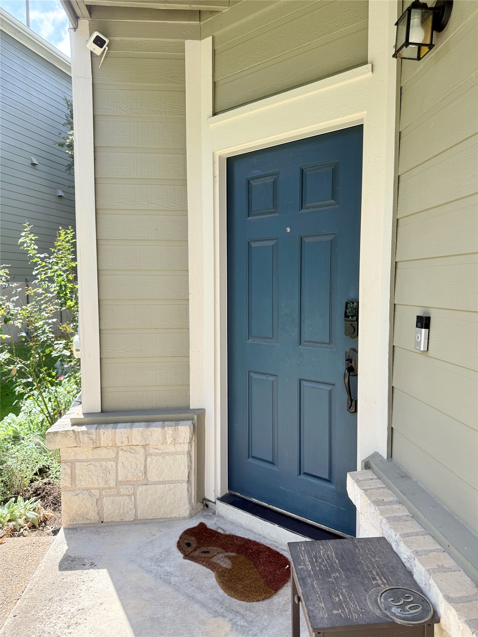 411 West St Elmo Road, Unit 39 Austin, TX 78745 - Photo 18 of 25 An inviting entrance porch features a paneled front door framed by clean white trim. Ring doorbell and keypad lock for added security.