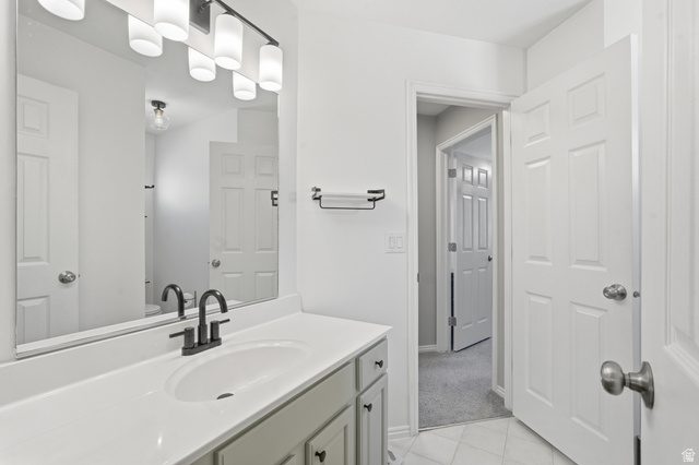 99 Penhurst Place Logan, UT 84341 - Photo 17 of 34 Bathroom vanity featuring an integrated sink, white countertop, and matte black faucet