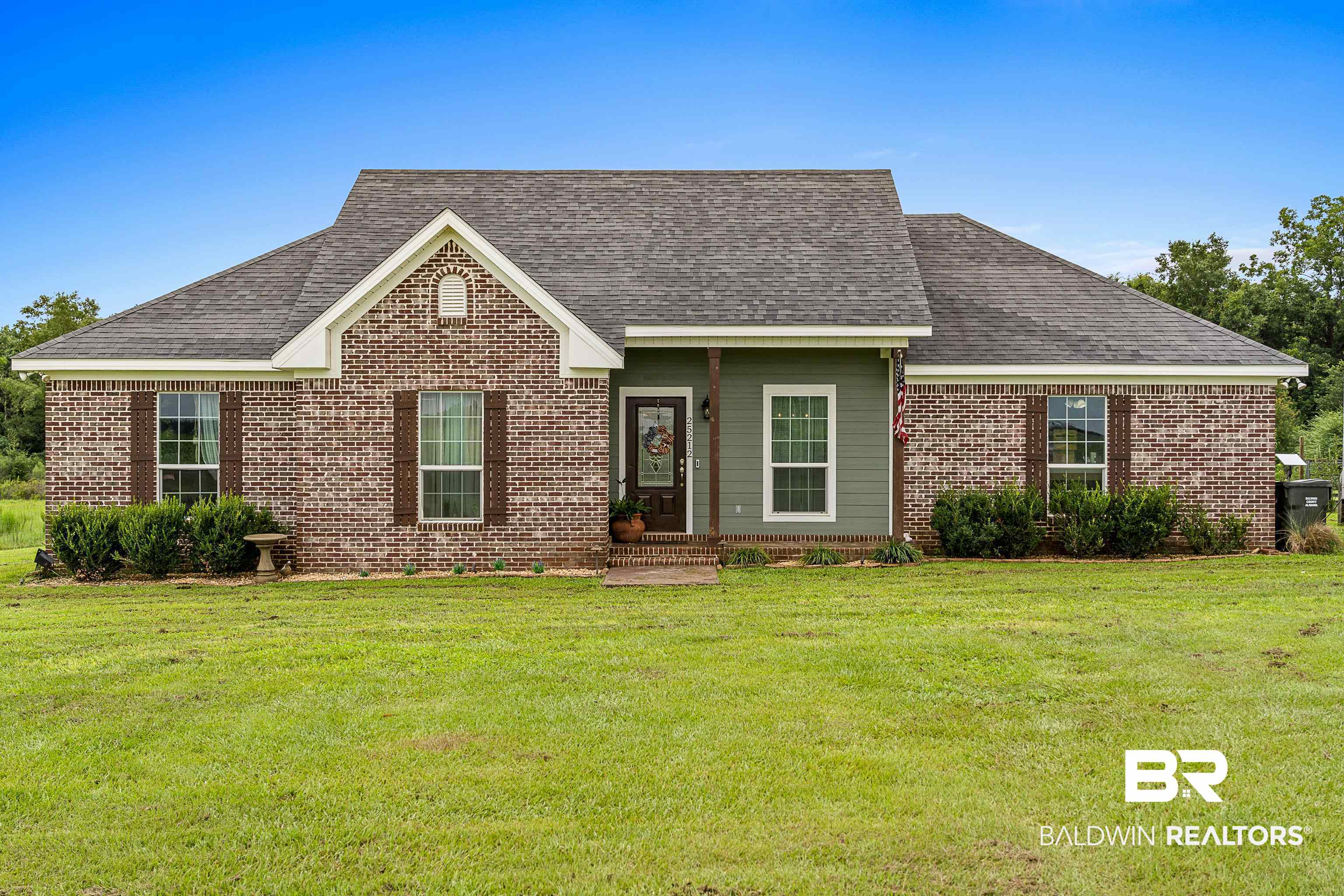 25212 Reeves Lane Elberta, AL 36530 - Photo 1 of 28 View of front of house featuring a shingled roof, a front yard, and brick siding