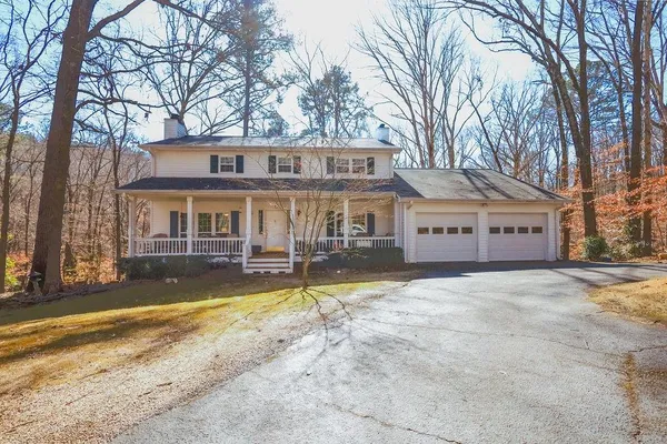a view of a house with a large trees in front of it