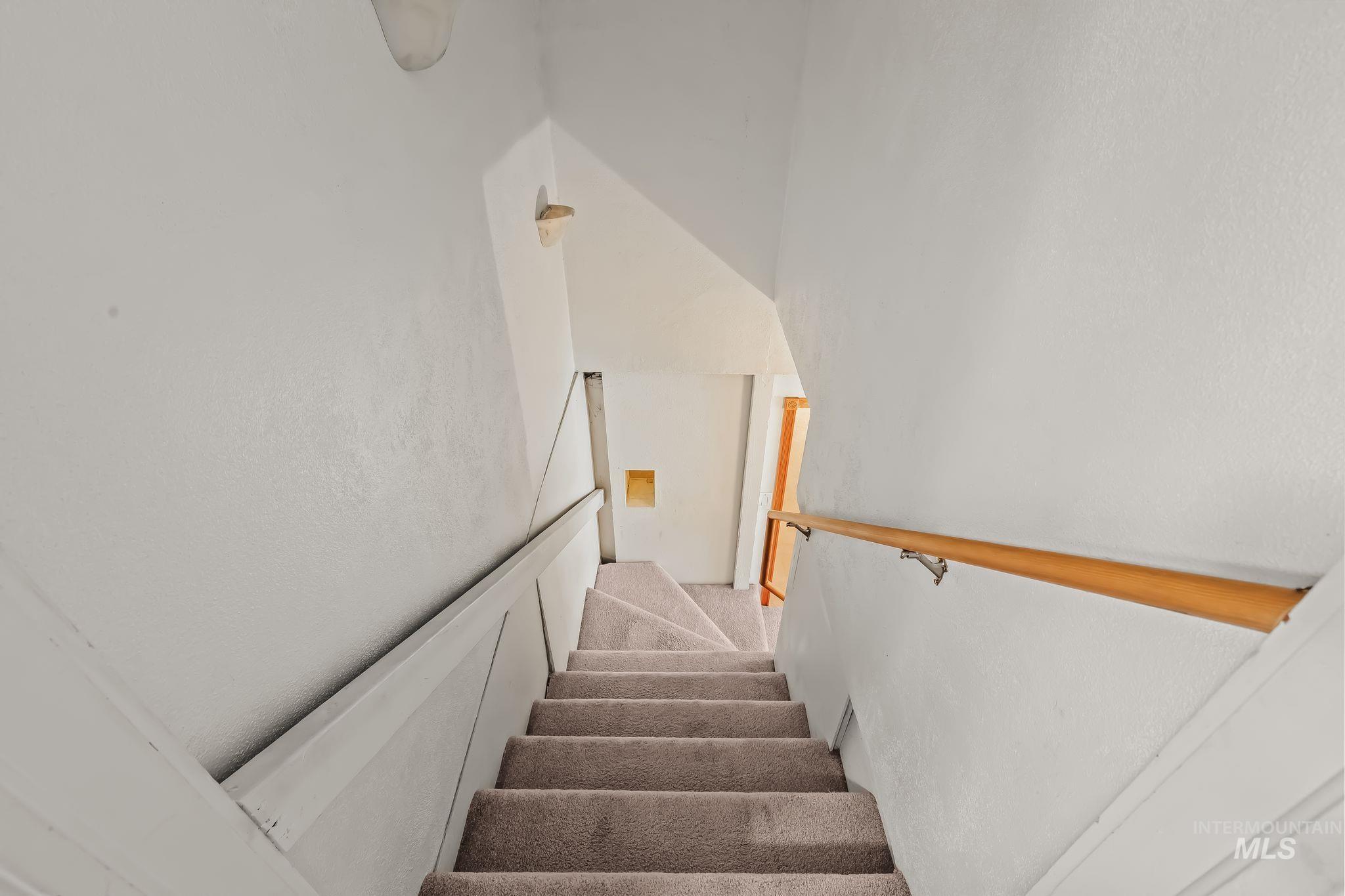 420 4th Street Lewiston, ID 83501 - Photo 20 of 38 Carpeted staircase with white walls and a light wood-finish handrail