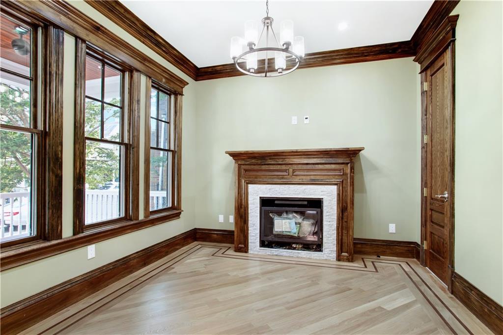 18 Buckingham Road Brooklyn, NY 11226 - Photo 4 of 15 a view of an empty room with wooden floor and a window
