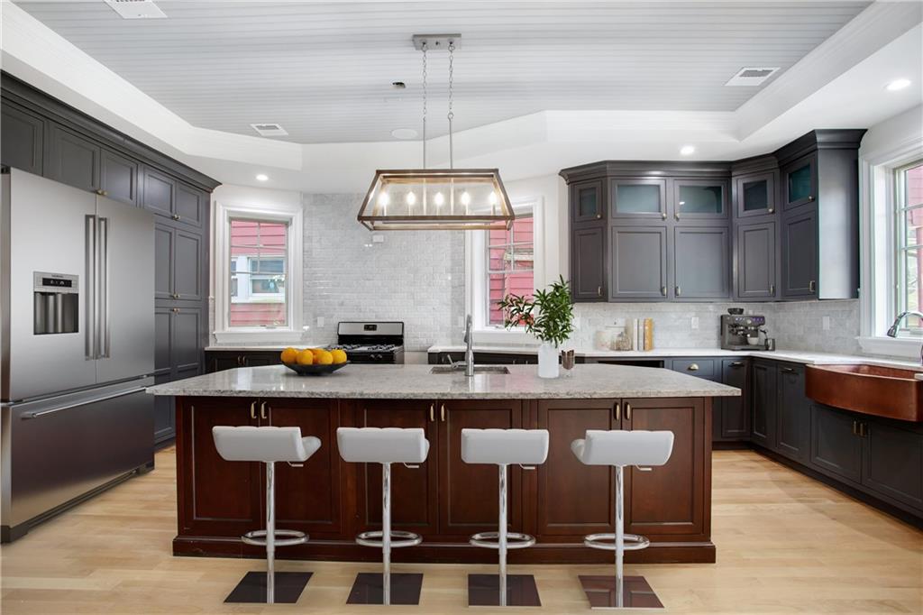 18 Buckingham Road Brooklyn, NY 11226 - Photo 7 of 15 a kitchen with stainless steel appliances granite countertop a sink a stove a dining table and chairs