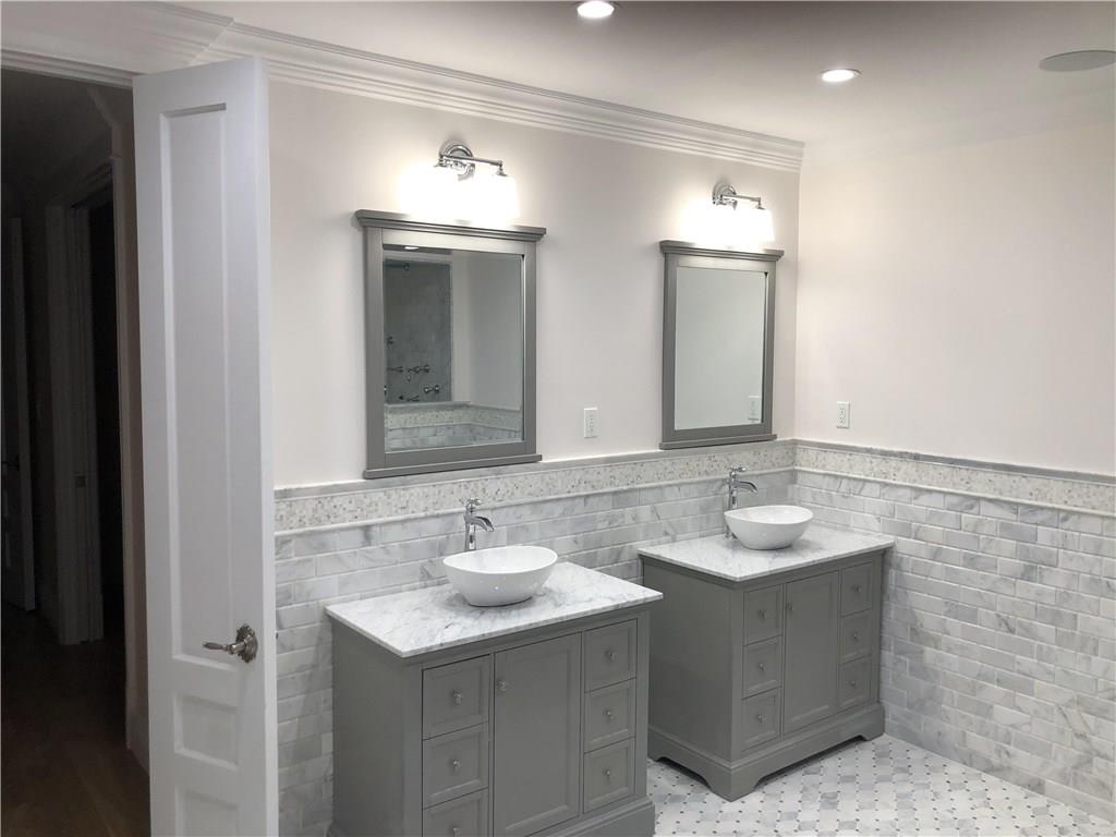 18 Buckingham Road Brooklyn, NY 11226 - Photo 10 of 15 a bathroom with double sink and two mirror