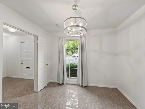 a view of room with window and chandelier