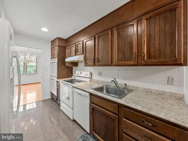 a kitchen with a sink cabinets and window