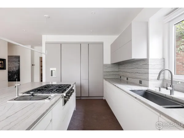 a kitchen with a sink stove and cabinets