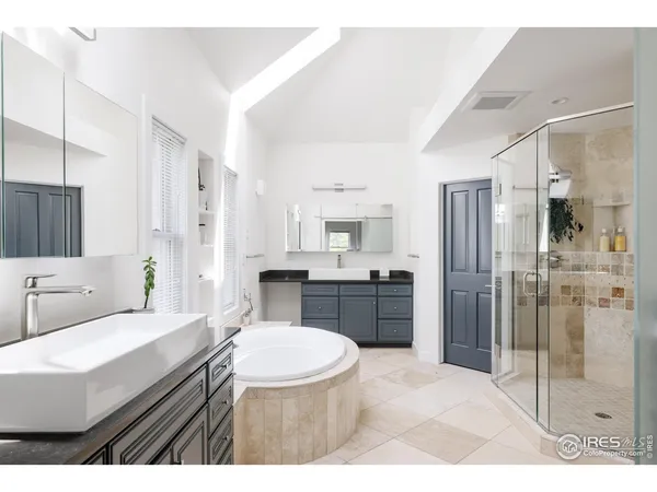 a bathroom with a sink a toilet a mirror and shower
