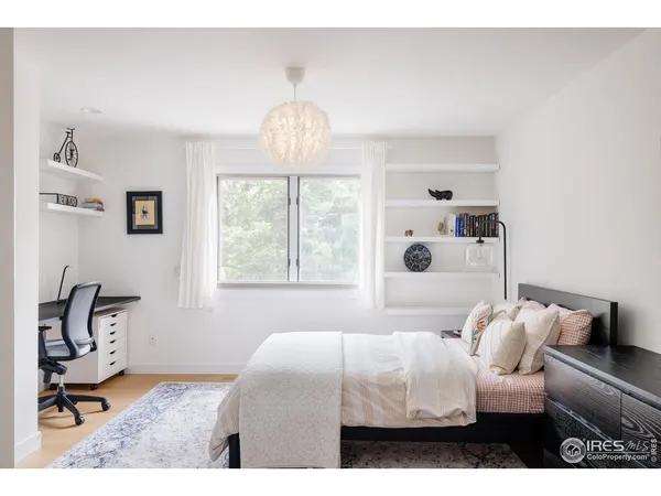 a bedroom with furniture and a chandelier