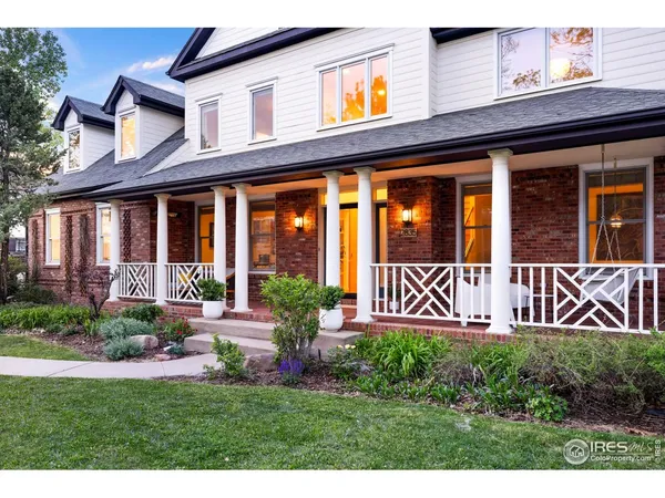 front view of a brick house with a yard