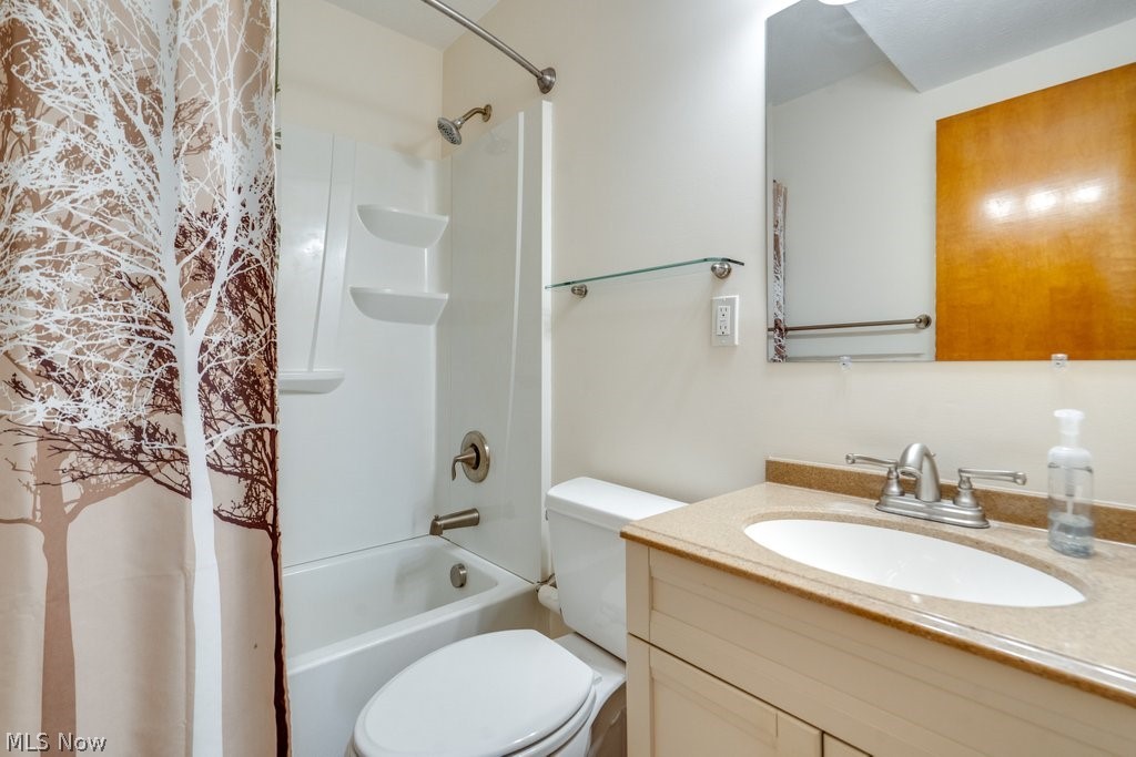 30000 Elgin Road Wickliffe, OH 44092 - Photo 15 of 30 Bathroom featuring a white tub/shower combination, brushed nickel fixtures, a neutral-toned vanity with an integrated sink, a rectangular mirror, and light-colored walls