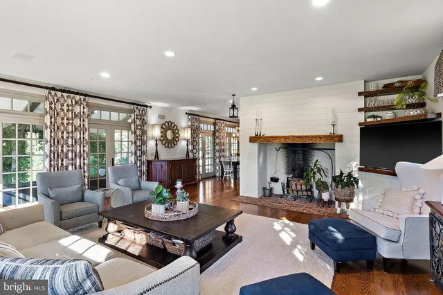 a spacious bedroom with a bed and wooden floor