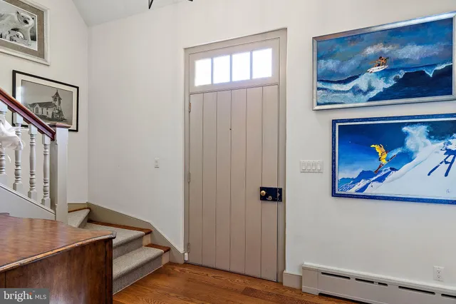 a view of a patio with table and chairs potted plants with floor to ceiling window
