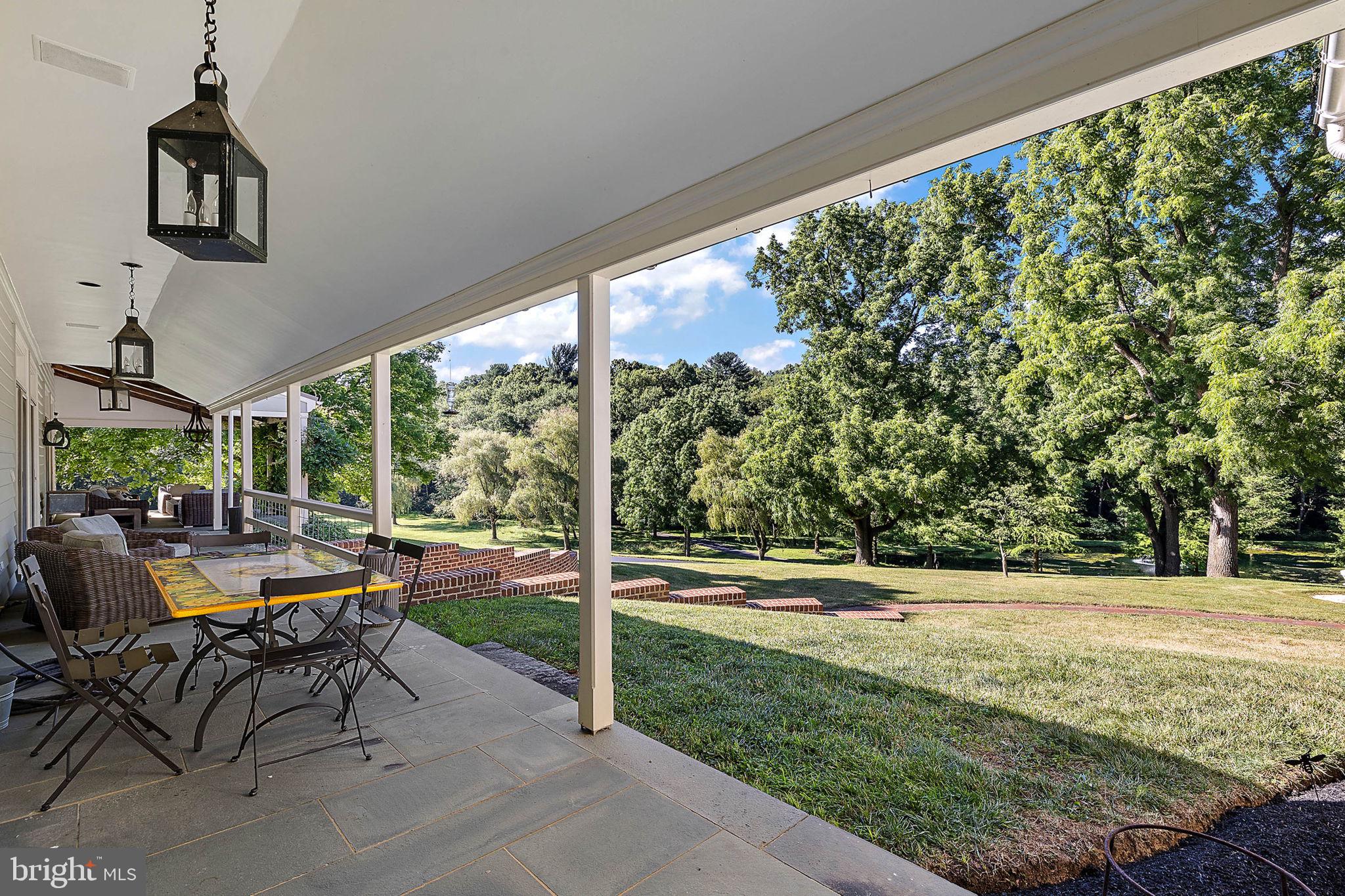 4635 Newark Road Cochranville, PA 19330 - Photo 48 of 113 a view of a patio with table and chairs potted plants with floor to ceiling window