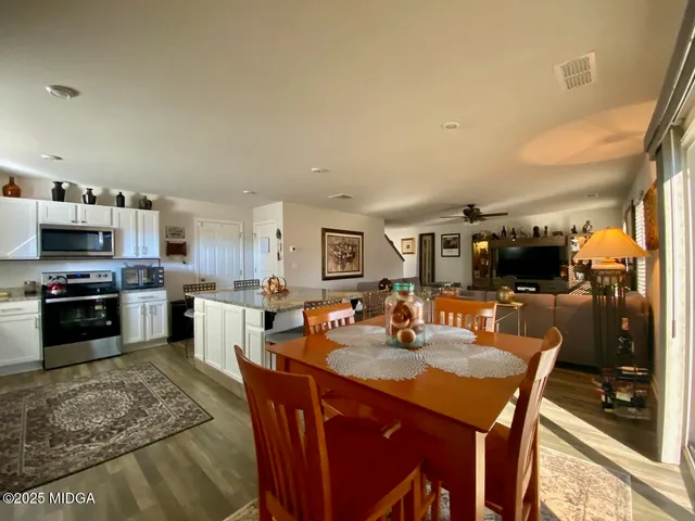 a kitchen with a sink a stove and chairs