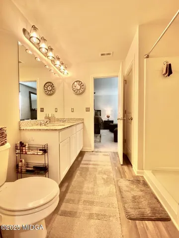 a bathroom with a sink a toilet and mirror