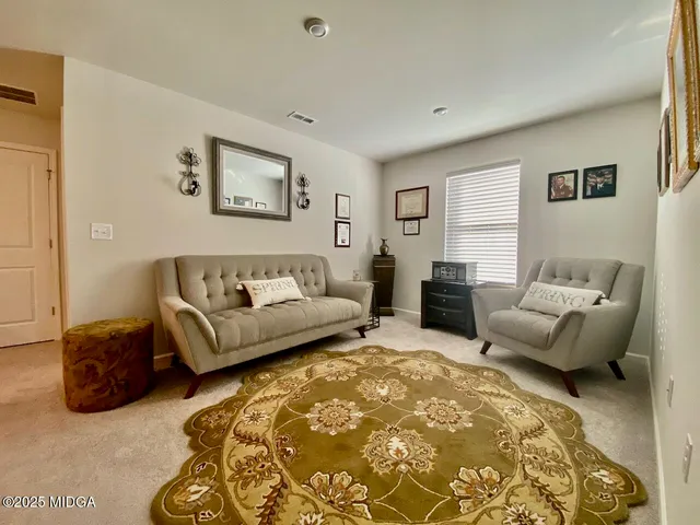 a spacious bedroom with a bed and couch