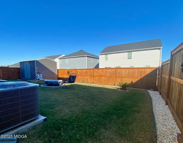 a view of a backyard with furniture