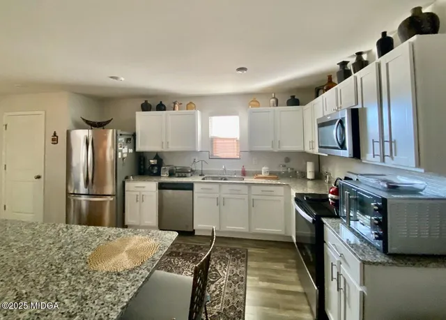 a kitchen with a refrigerator stove and sink