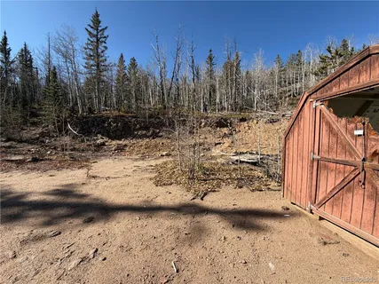 a view of a wooden fence with a yard