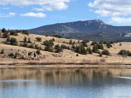 a view of a swimming pool with a yard and sitting space