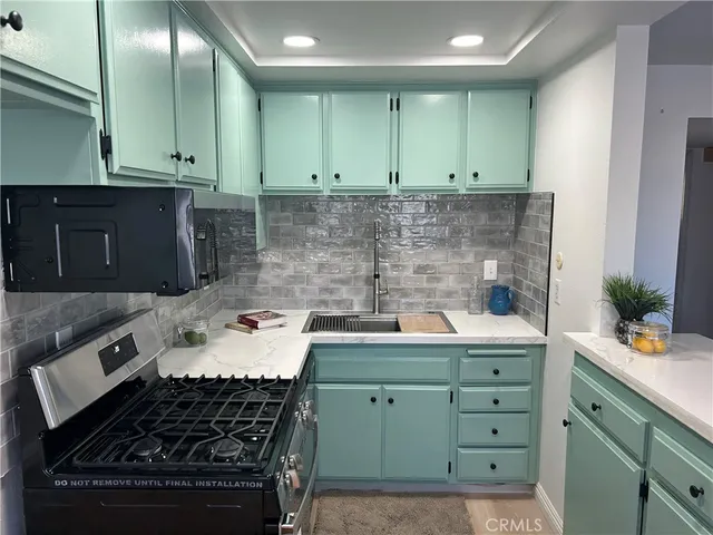a kitchen with a stove and cabinets