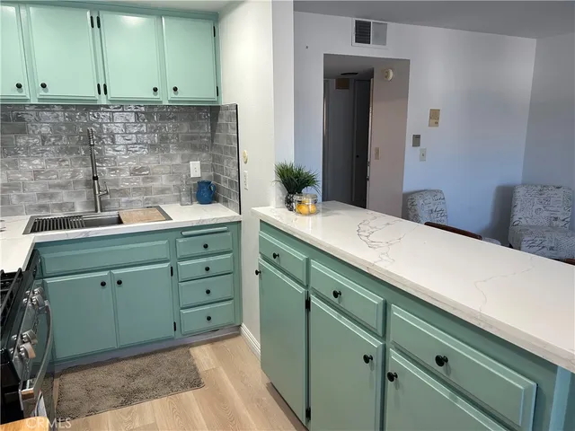 a room with a sink and cabinets
