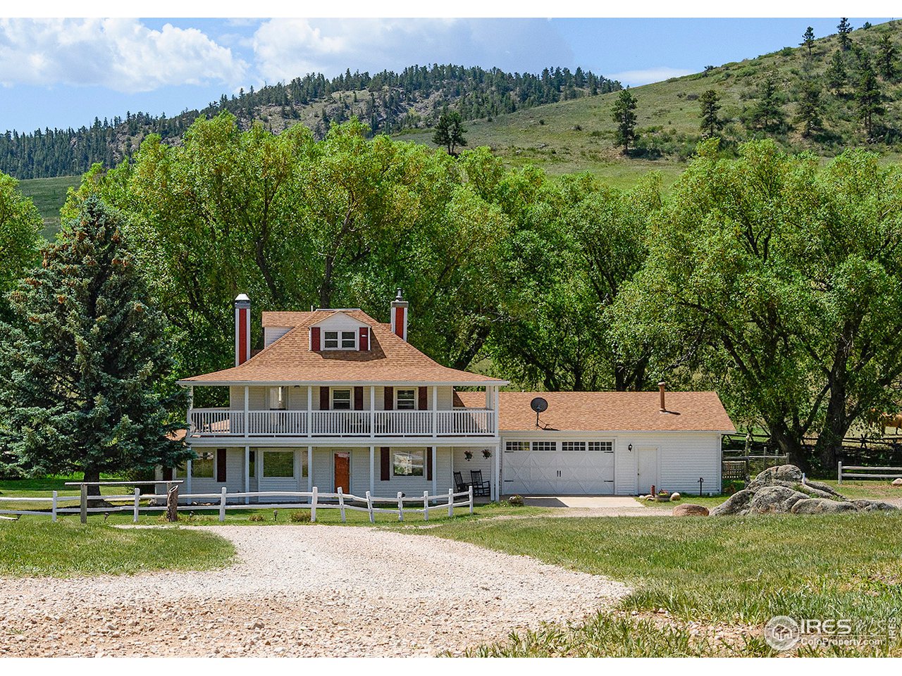 222 Boxer Ranch Road Livermore, CO 80536 - Photo 1 of 28 an aerial view of a house with a garden and a yard