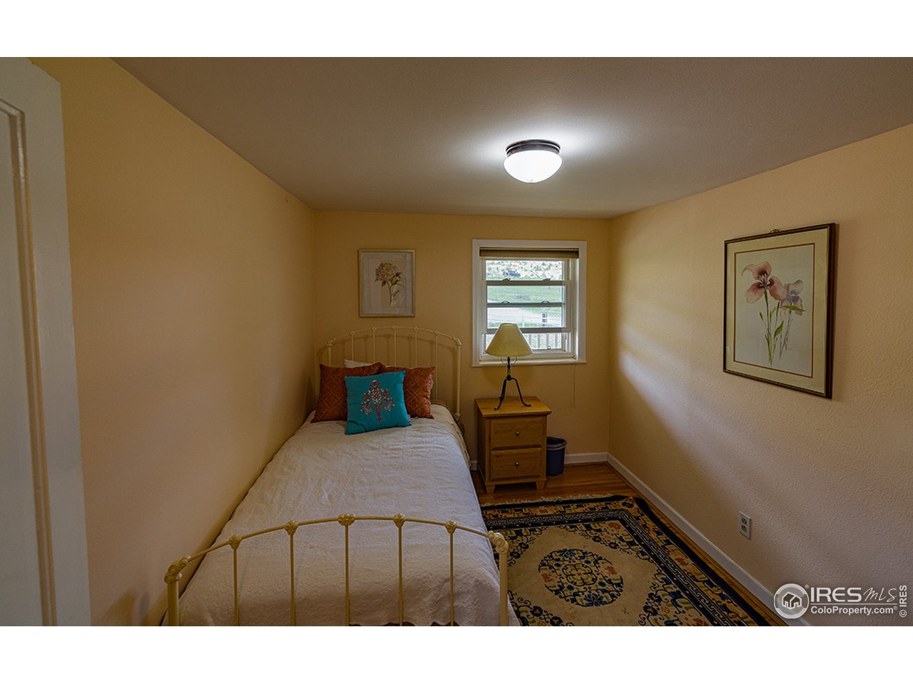 222 Boxer Ranch Road Livermore, CO 80536 - Photo 15 of 28 a bedroom with furniture and a window