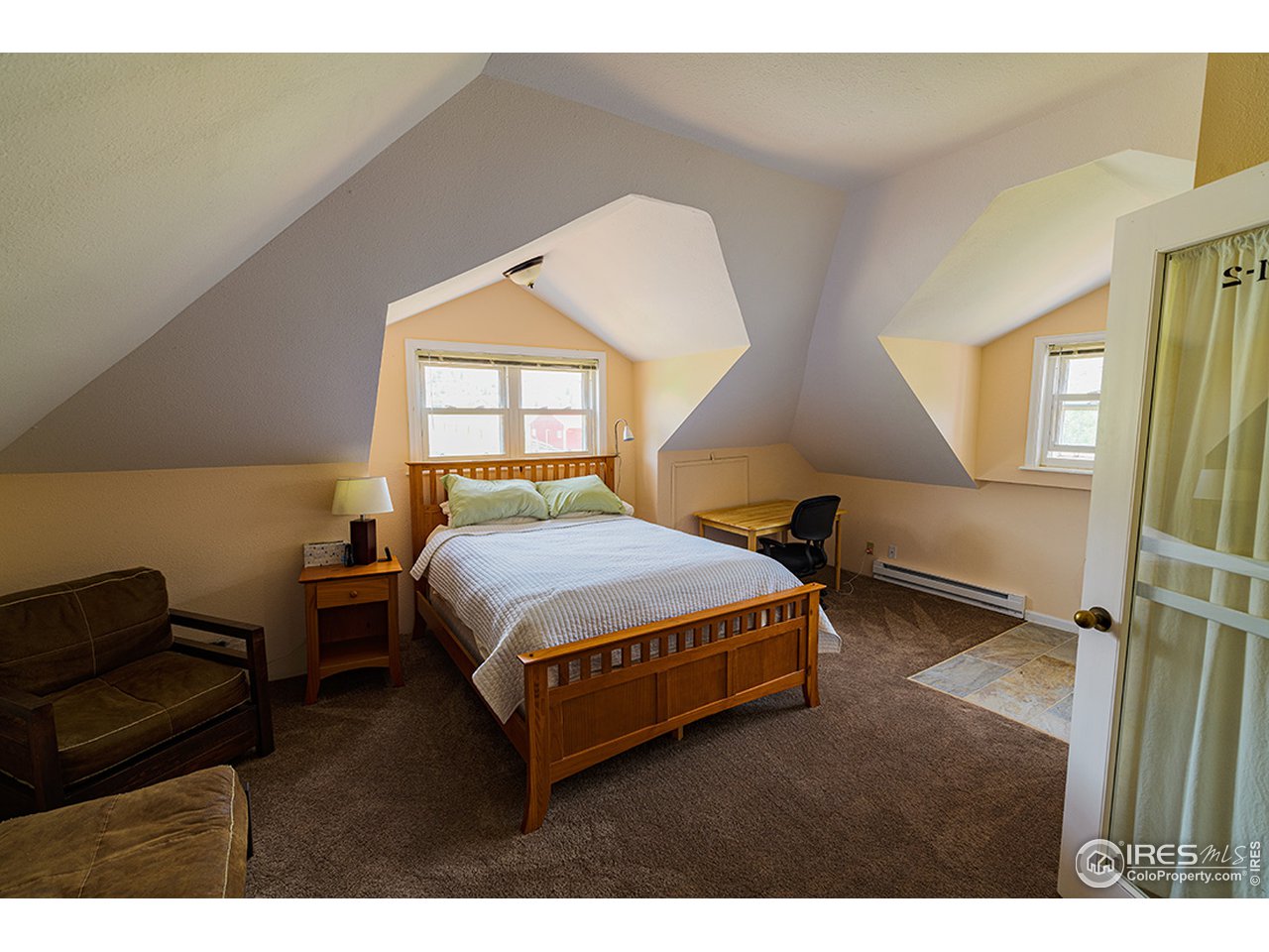 222 Boxer Ranch Road Livermore, CO 80536 - Photo 16 of 28 a bedroom with a bed window and a night stand