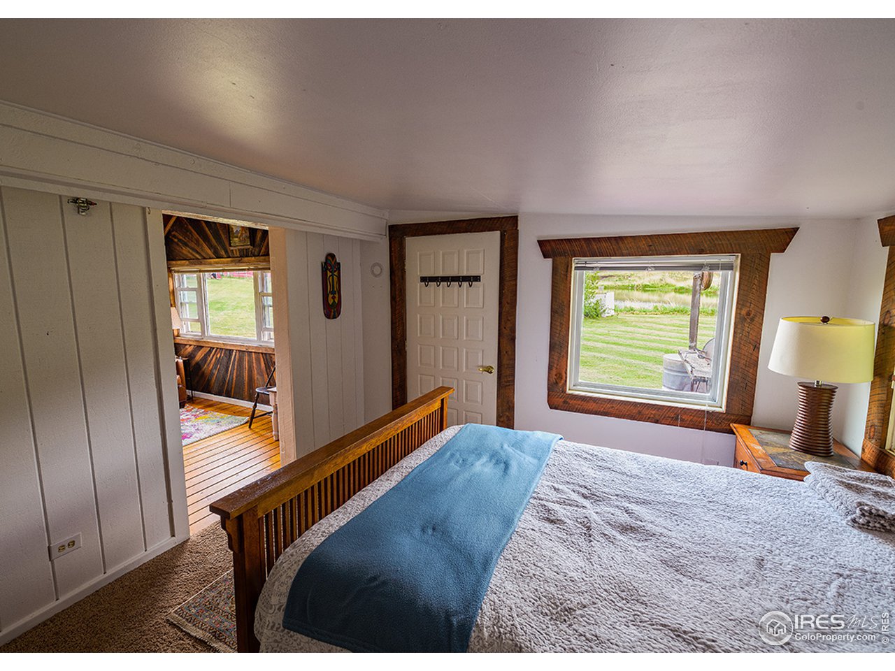 222 Boxer Ranch Road Livermore, CO 80536 - Photo 22 of 28 a bedroom with a bed and wooden floor