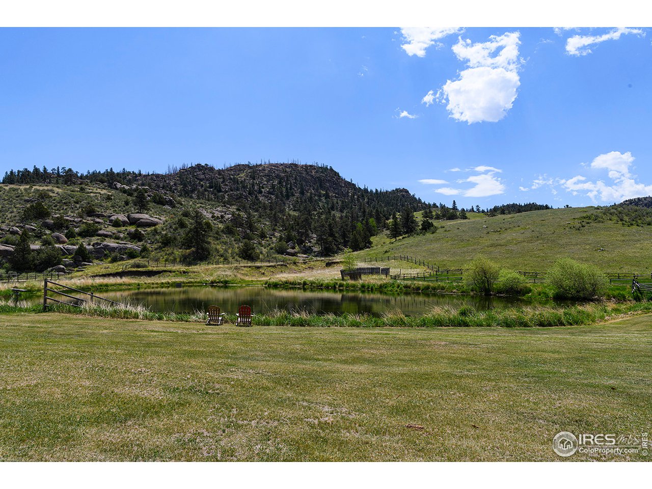 222 Boxer Ranch Road Livermore, CO 80536 - Photo 3 of 28 a view of a lake with sunset