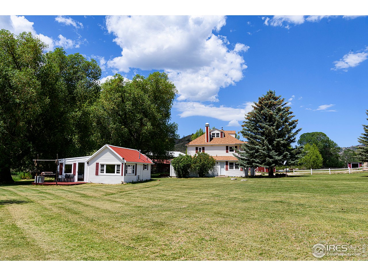 222 Boxer Ranch Road Livermore, CO 80536 - Photo 6 of 28 a view of house with outdoor space and trees in the background