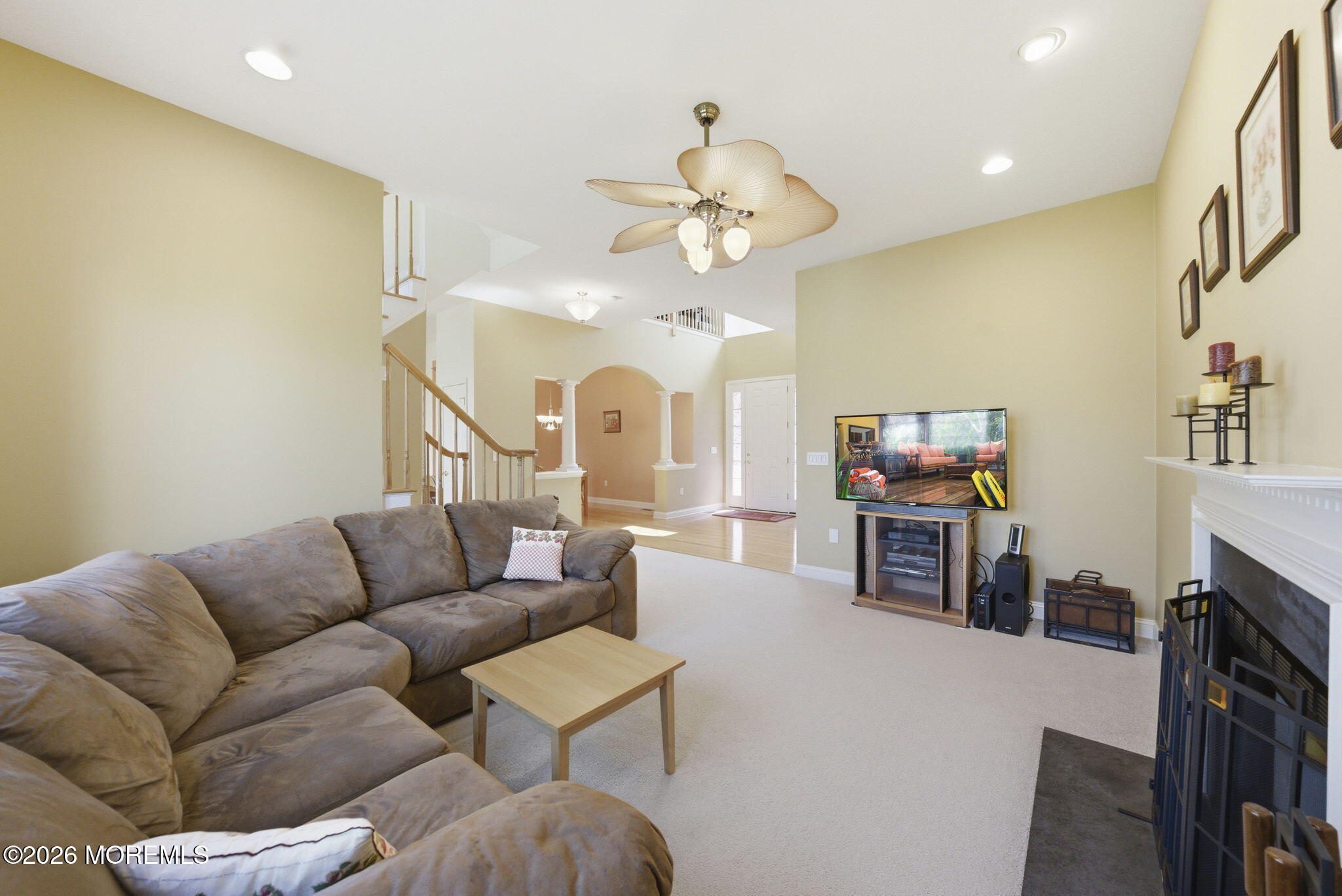 20 Royal Lane Howell, NJ 07731 - Photo 15 of 53 a living room with furniture a fireplace and a flat screen tv