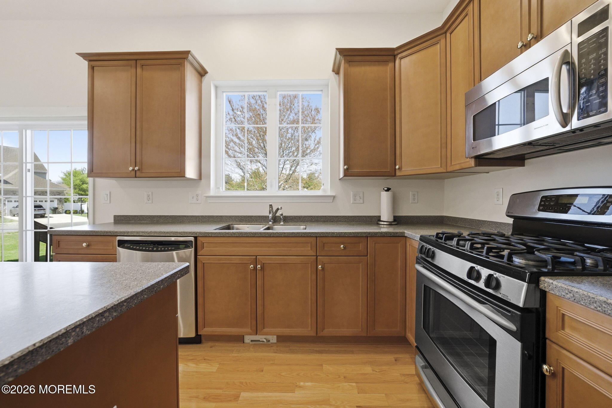 20 Royal Lane Howell, NJ 07731 - Photo 19 of 53 a kitchen with stainless steel appliances granite countertop a stove a sink and a microwave