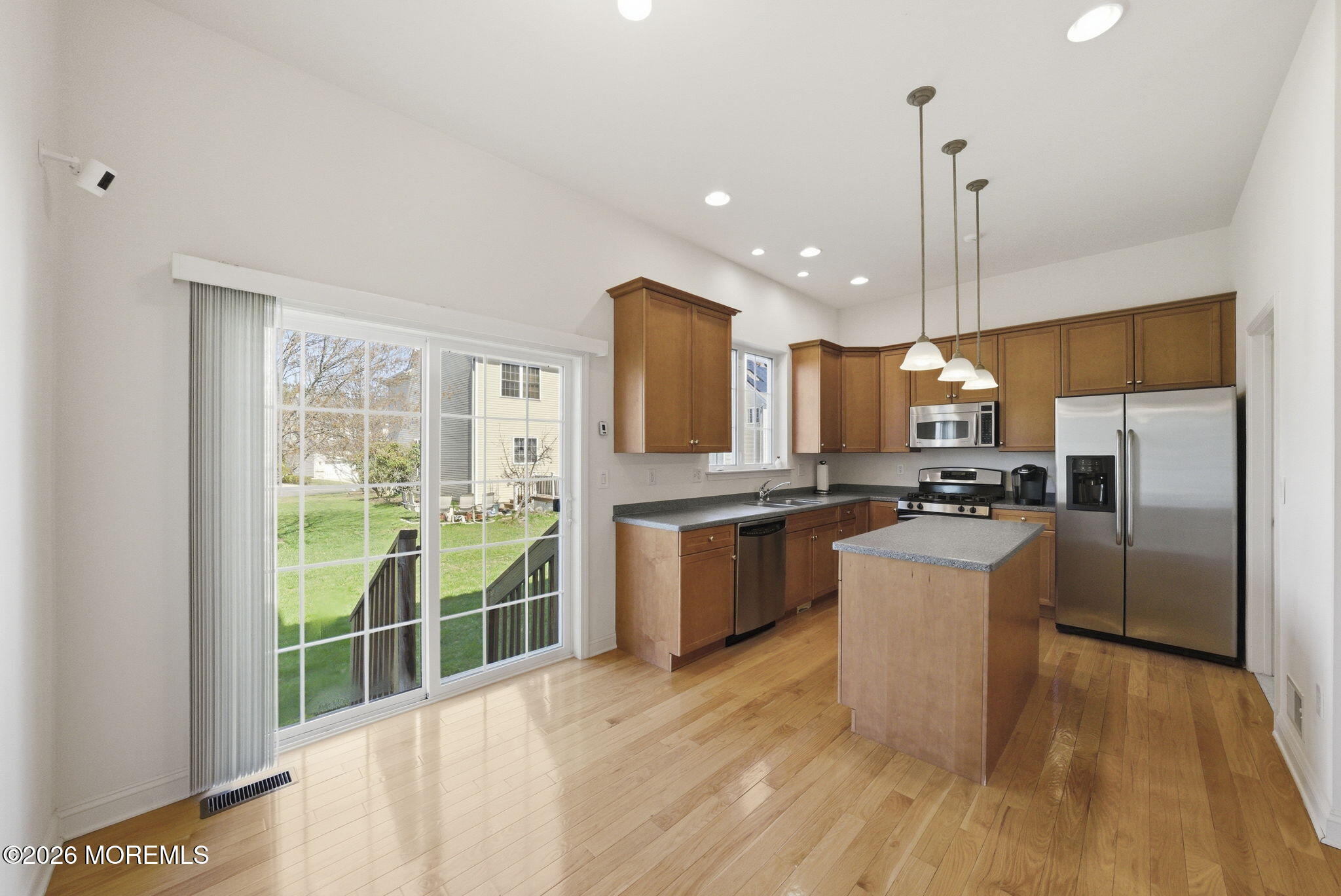 20 Royal Lane Howell, NJ 07731 - Photo 20 of 53 a kitchen with stainless steel appliances kitchen island granite countertop a refrigerator a sink a stove and a wooden floors