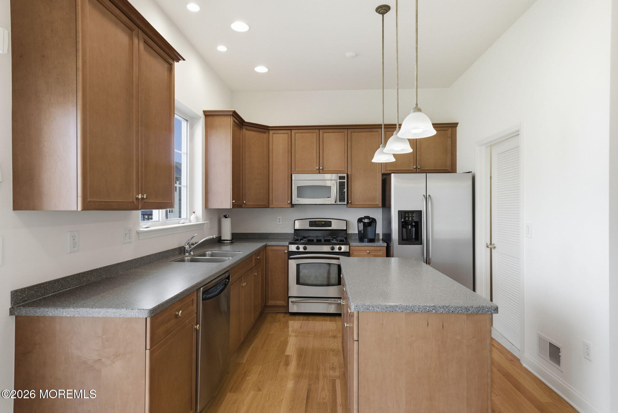 20 Royal Lane Howell, NJ 07731 - Photo 21 of 53 a kitchen with stainless steel appliances granite countertop a sink a stove and a refrigerator