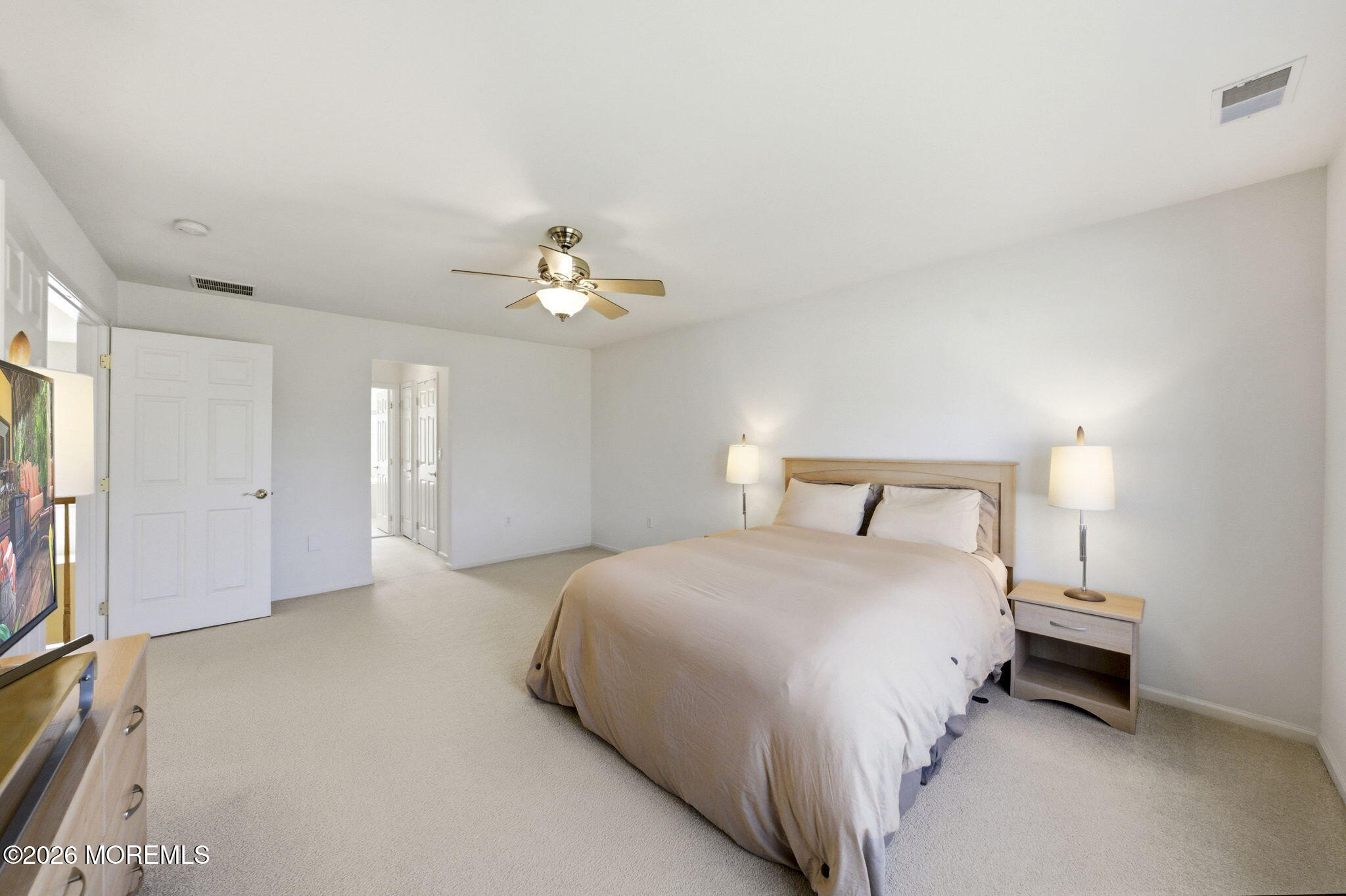 20 Royal Lane Howell, NJ 07731 - Photo 31 of 53 a spacious bedroom with a bed and a chandelier