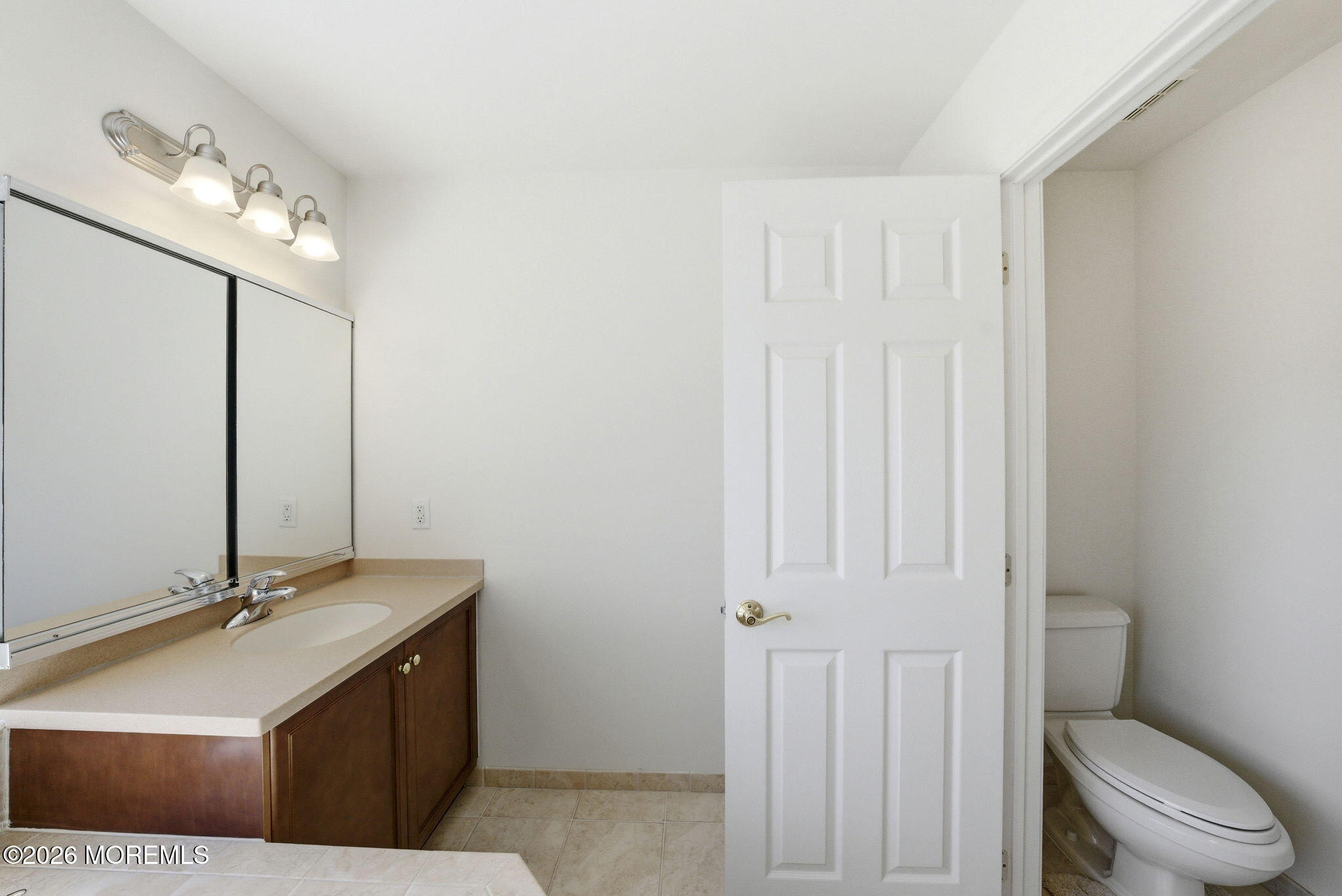 20 Royal Lane Howell, NJ 07731 - Photo 36 of 53 a bathroom with a toilet a sink a mirror and vanity
