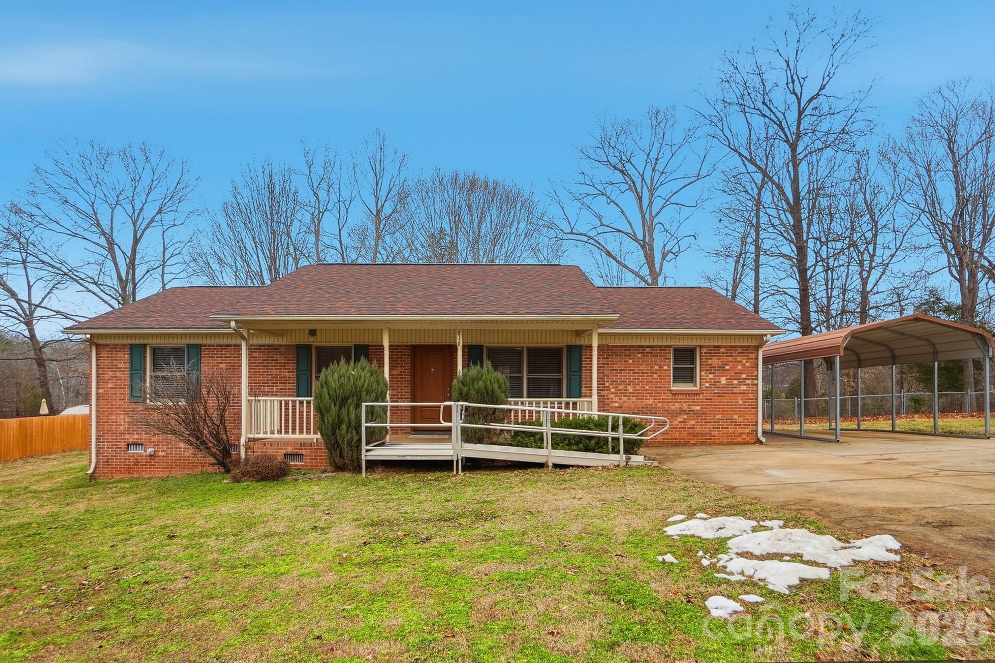 a backyard of a house with barbeque oven table and chairs