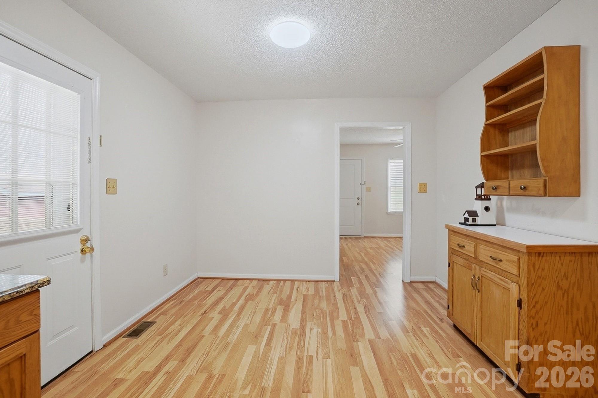 616 Durham Road Stanley, NC 28164 - Photo 12 of 42 a view of a kitchen with wooden floor and electronic appliances