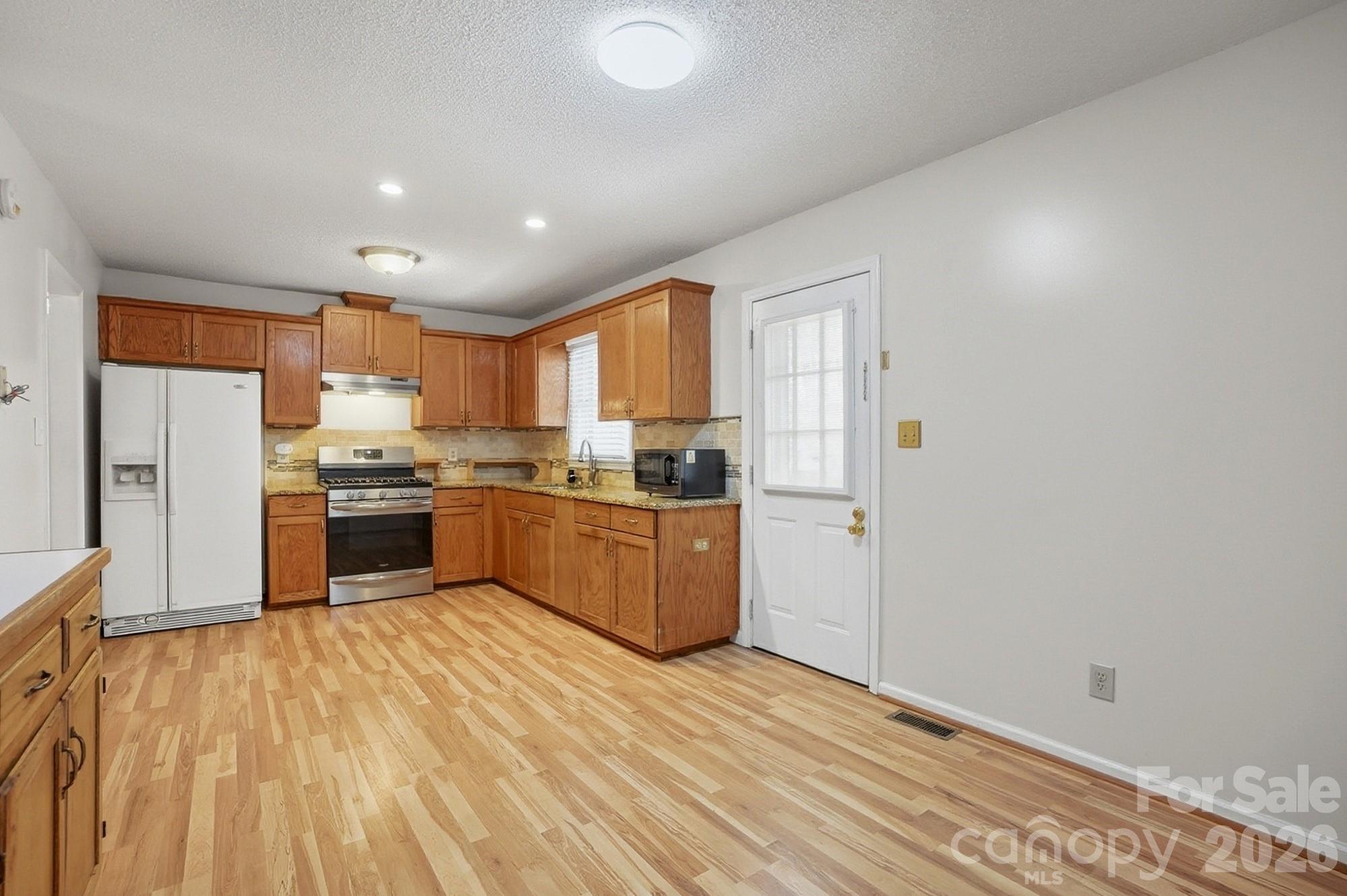 616 Durham Road Stanley, NC 28164 - Photo 15 of 42 a kitchen with a refrigerator and a sink