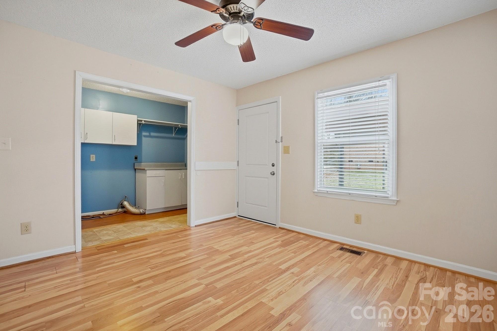 616 Durham Road Stanley, NC 28164 - Photo 17 of 42 a view of empty room with wooden floor and fan