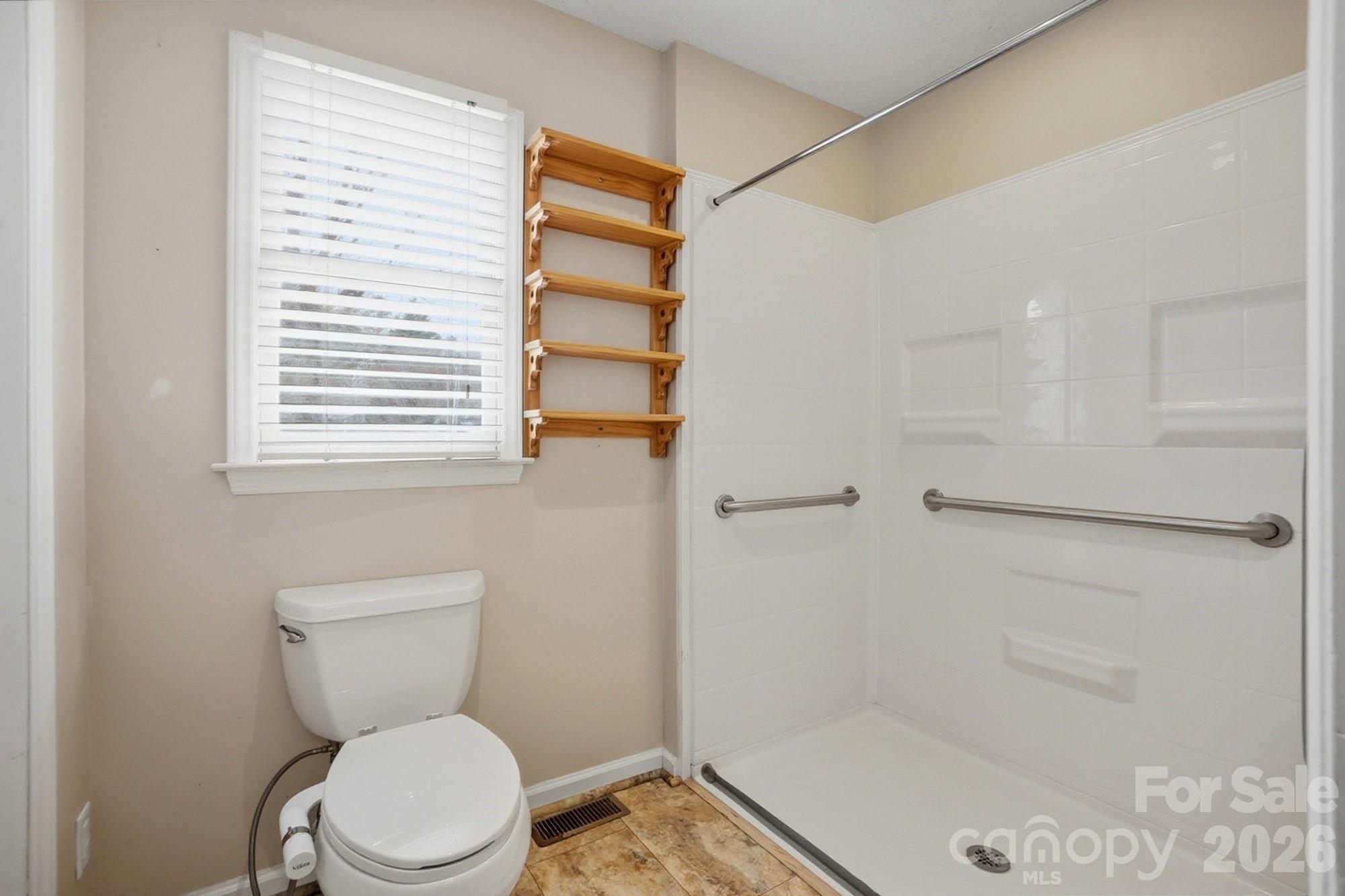 616 Durham Road Stanley, NC 28164 - Photo 20 of 42 a bathroom with a toilet and a shower