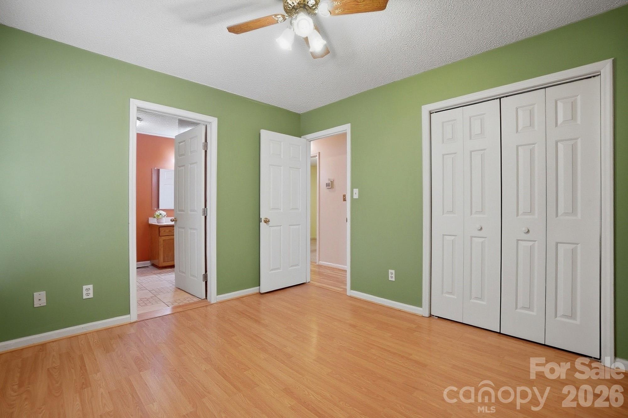 616 Durham Road Stanley, NC 28164 - Photo 24 of 42 an empty room with closet and a chandelier fan