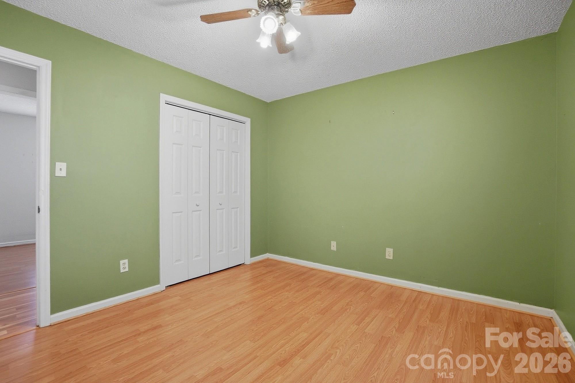 616 Durham Road Stanley, NC 28164 - Photo 25 of 42 an empty room with a windows and chandelier fan