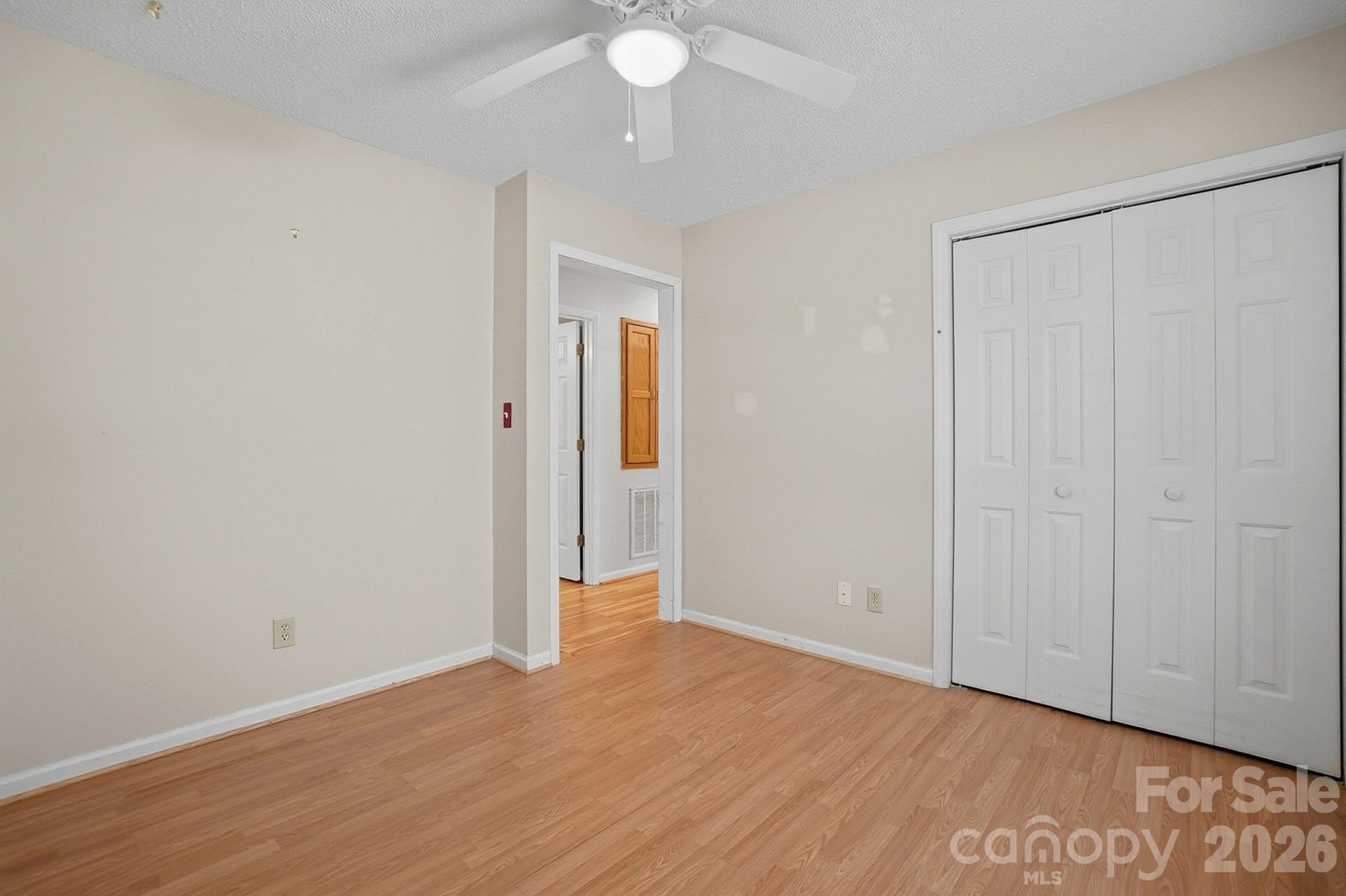 616 Durham Road Stanley, NC 28164 - Photo 29 of 42 an empty room with wooden floor and closet area