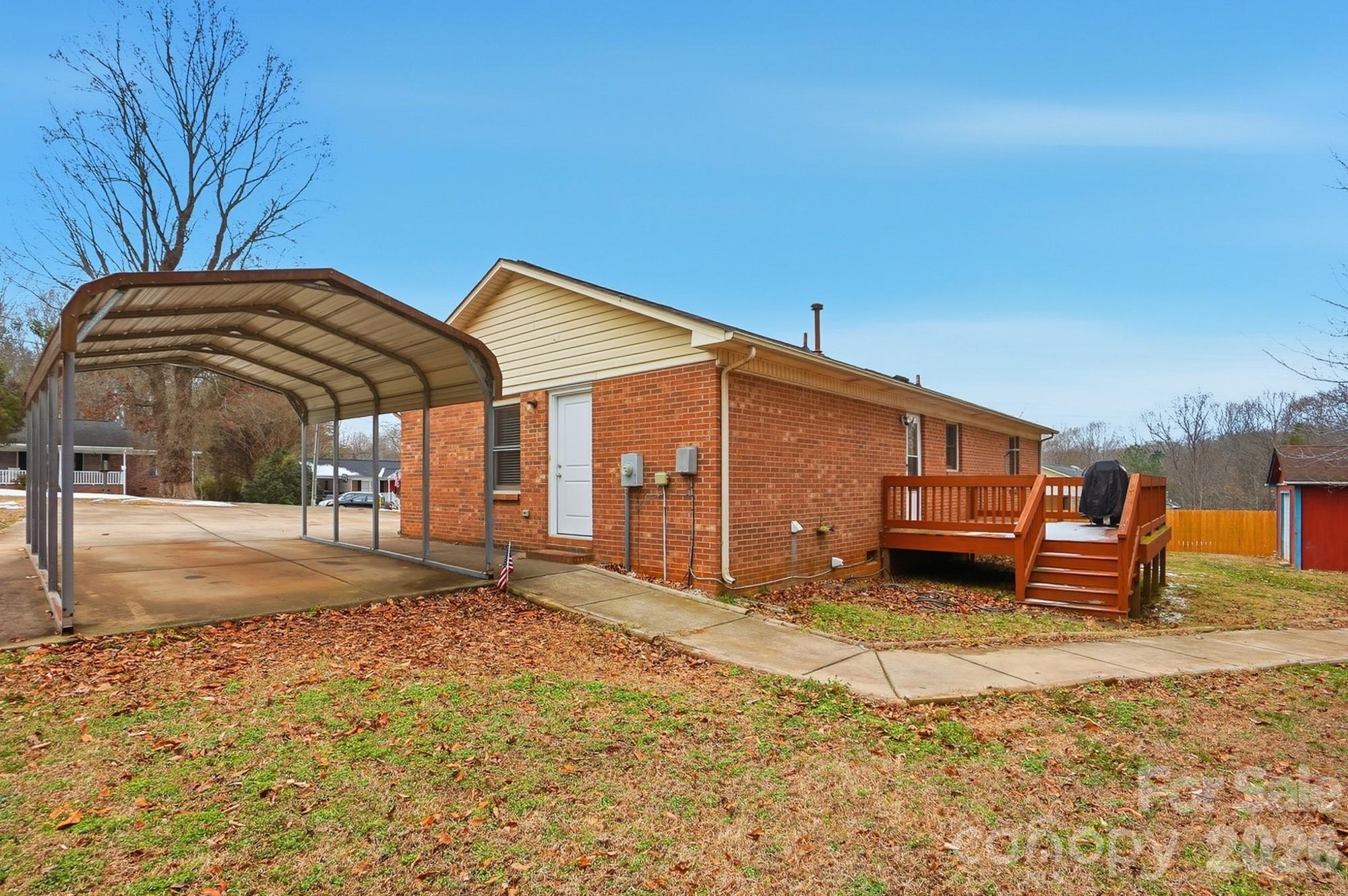 616 Durham Road Stanley, NC 28164 - Photo 32 of 42 a backyard of a house with barbeque oven and outdoor seating