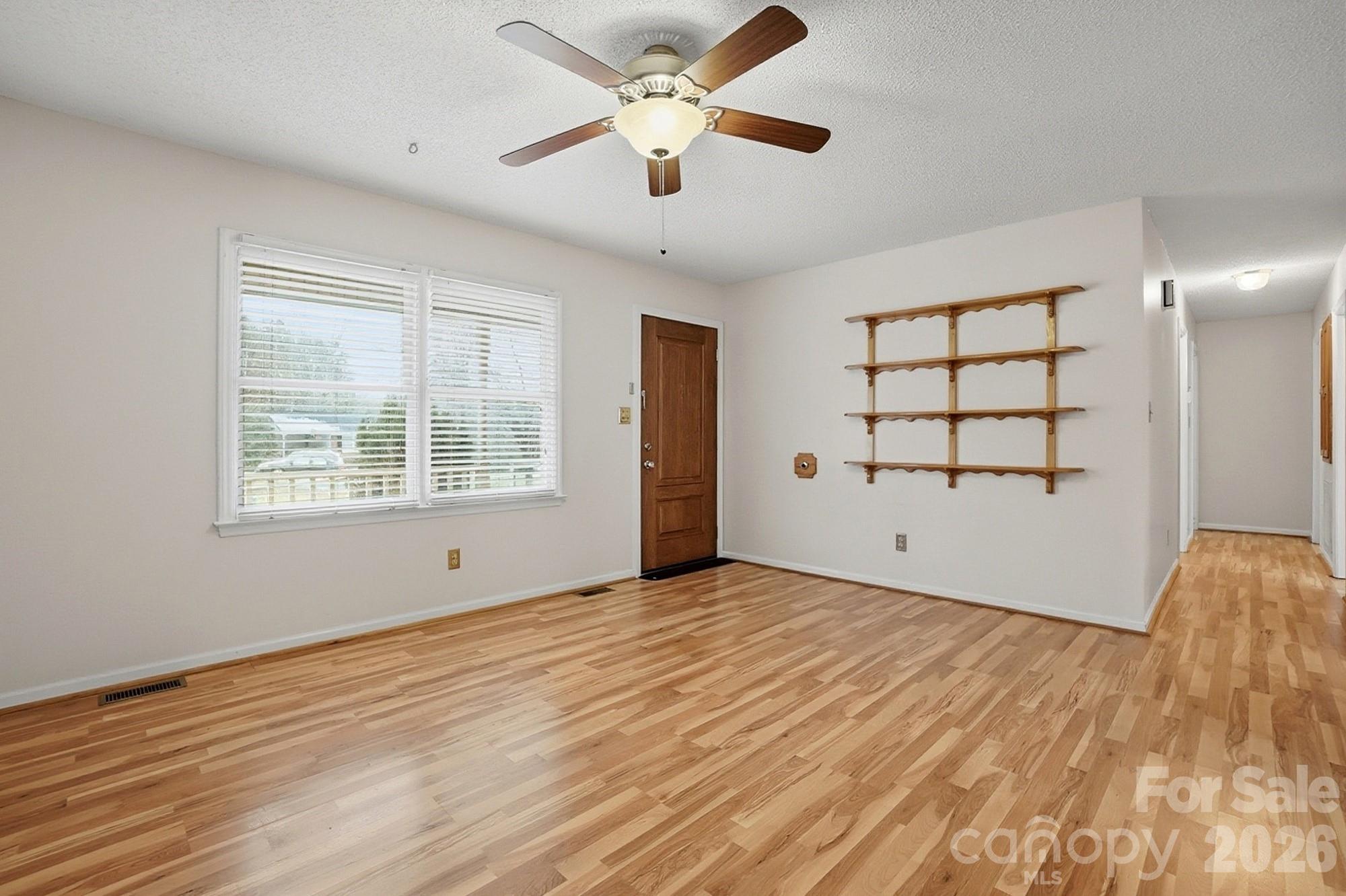 616 Durham Road Stanley, NC 28164 - Photo 4 of 42 a view of an empty room with wooden floor and a window